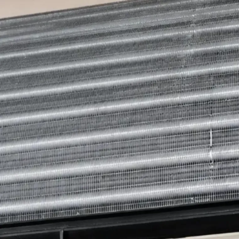 The same coil after cleaning, back to bare aluminum fins you can see between